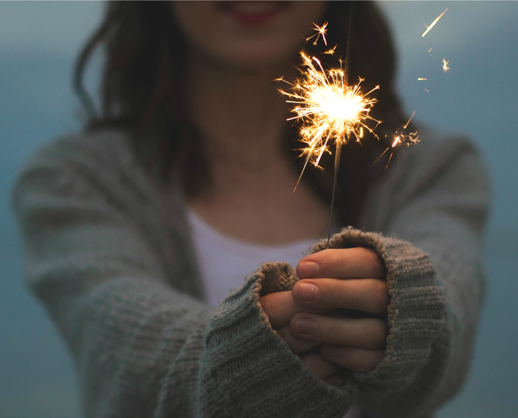 Woman celebrating New Year's vacation with a sparkler